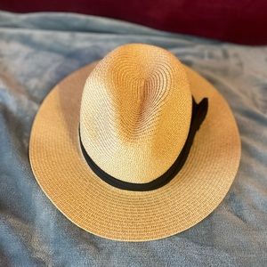 This is a brown/tan sun hat with a black ribbon on it